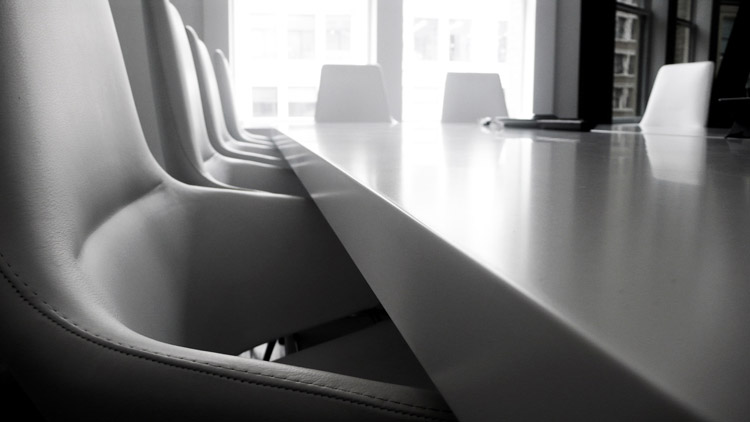 Spatial Environments - Image showing a boardroom scene with
                white leather executive chairs and table