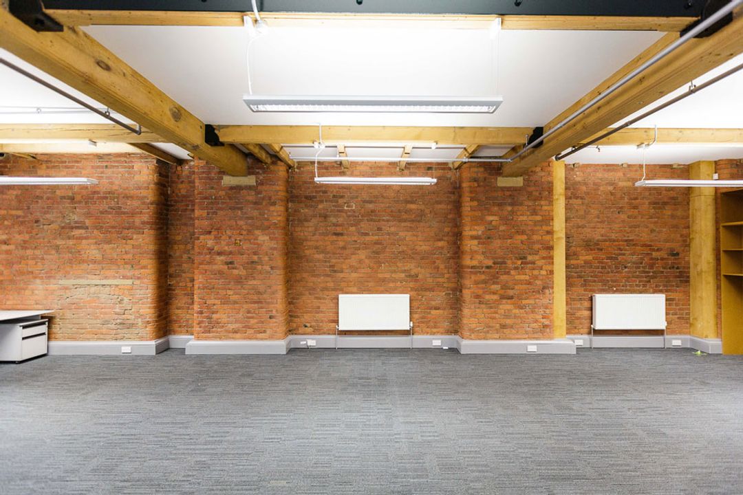 Buffalo 7 - Office space
                    before fit out and furniture installation. Showing view
                    of exposed brickwork and beams