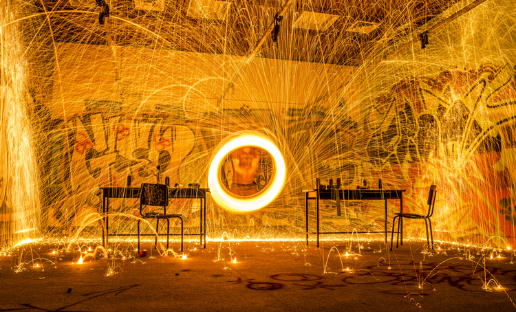 A circle of fire surrounding an office desk - (Photo by
                Dark Day)