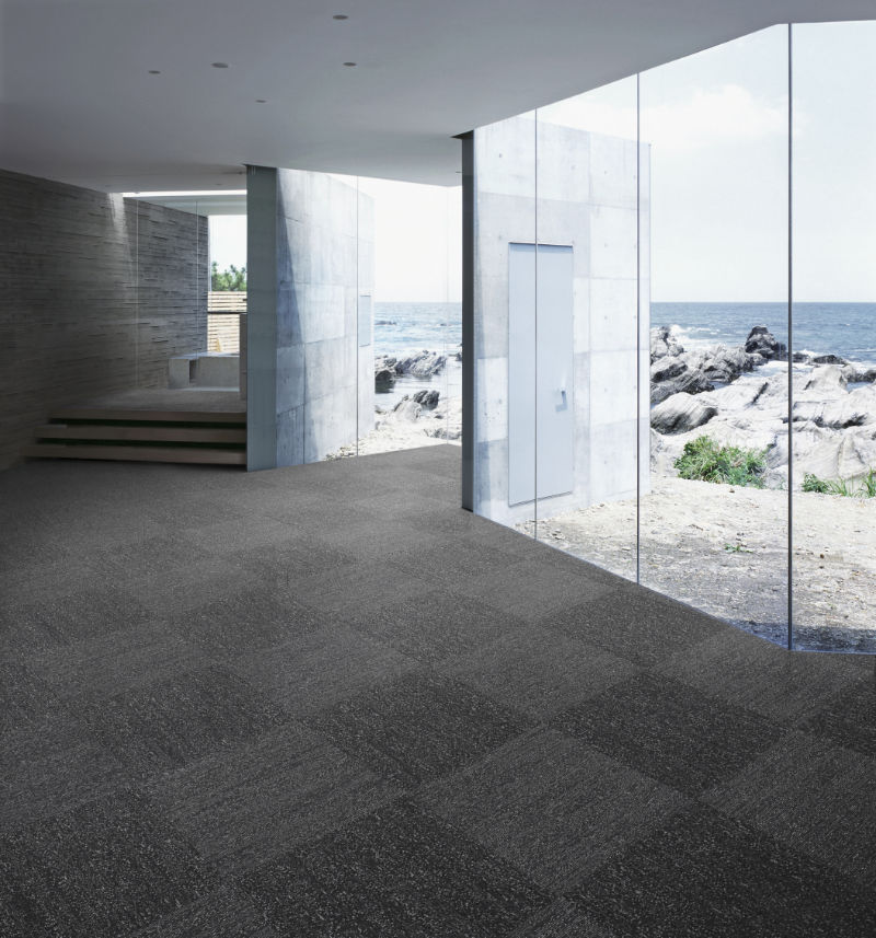 Modulyss 47 Grind - shows carpet tiles in grey laid out in
                a modern minimalistic house setting.